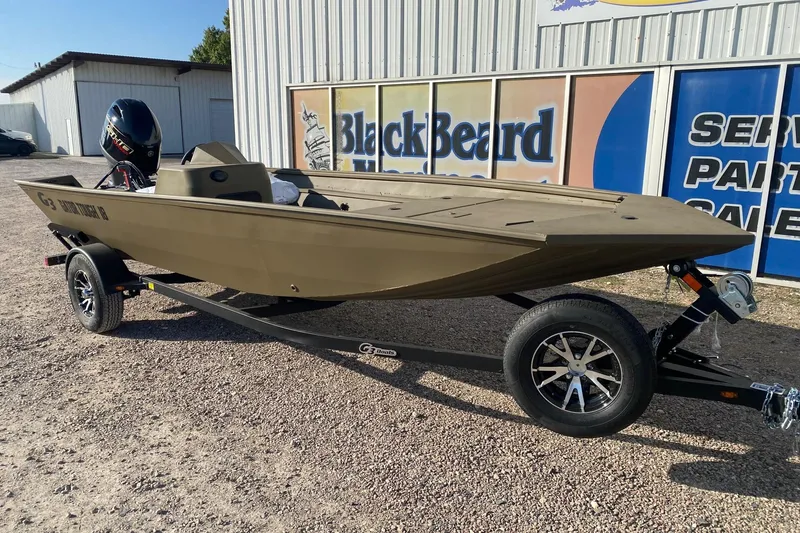Slide: The Image of 2026 G3 Gator Tough 18 CC boat on trailer, parked outdoors. - 1