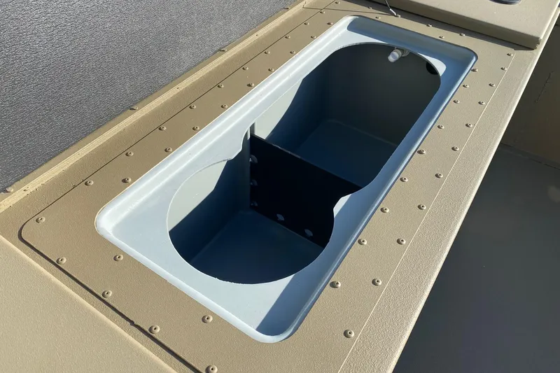 Slide: The Image of 2026 G3 Gator Tough 18 CC boat storage compartment, beige and gray design. - 10