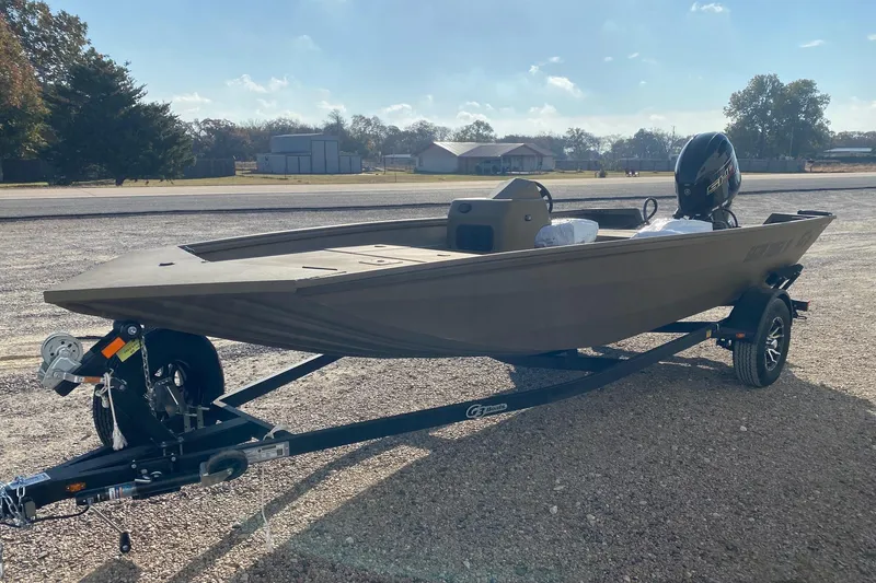 Slide: The Image of 2026 G3 Gator Tough 18 CC boat on trailer, parked outdoors under clear sky. - 2