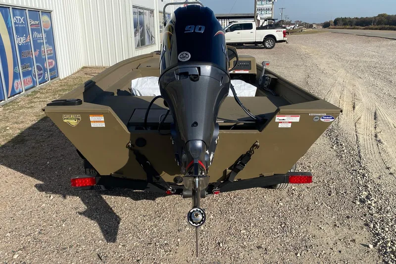Slide: The Image of 2026 G3 Gator Tough 18 CC boat with outboard motor, parked on gravel. - 4
