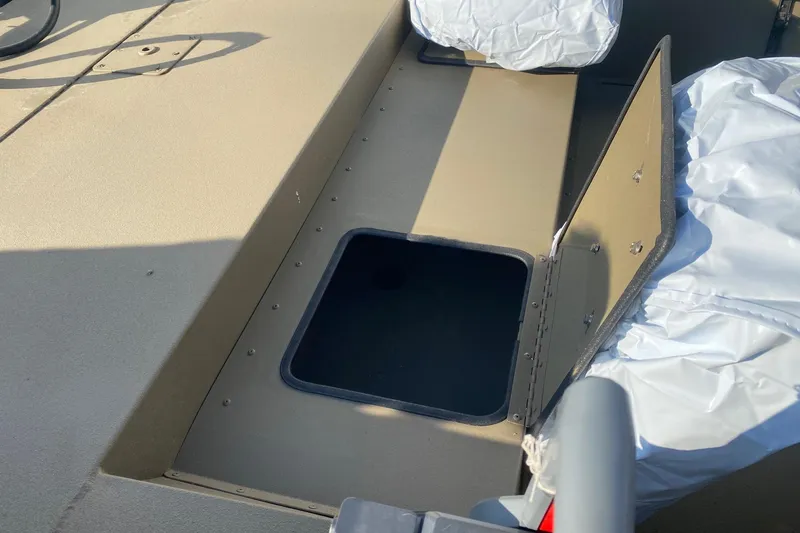 Slide: The Image of 2026 G3 Gator Tough 18 CC boat storage compartment with open hatch. - 7