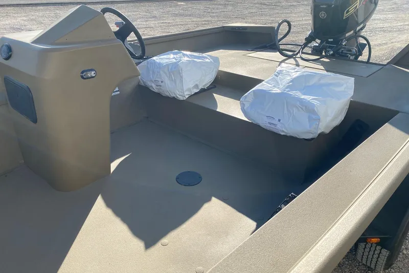 Slide: The Image of 2026 G3 Gator Tough 18 CC boat interior with covered seats and steering console. - 9