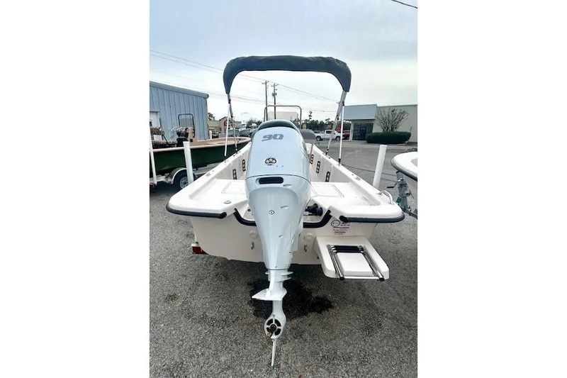 Slide: The Image of 2026 Carolina Skiff E20 JVX CC boat with outboard motor, rear view. - 4