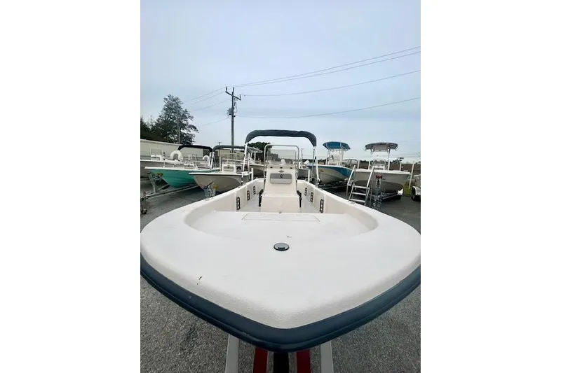 Slide: The Image of 2026 Carolina Skiff E20 JVX CC boat displayed in a marina setting. - 5