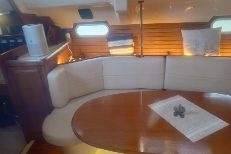 Slide: The Image of Interior of 1997 Hunter Passage 42 yacht with cozy seating and wooden table. - 13