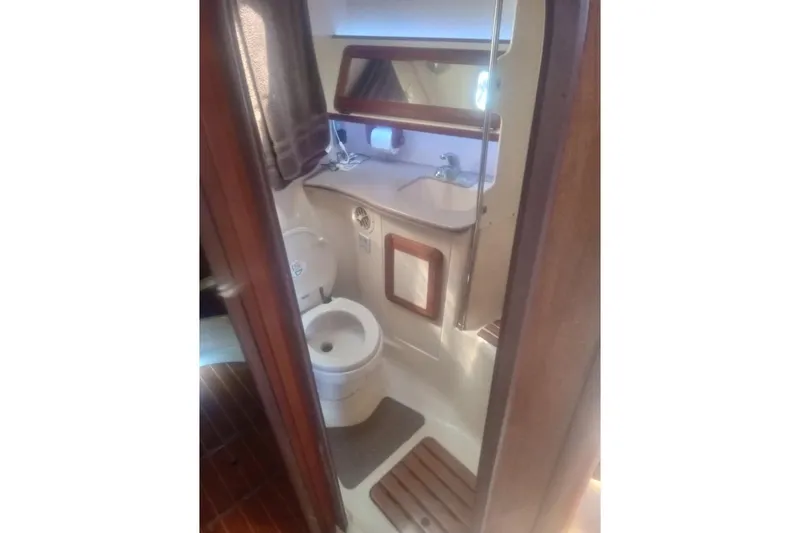 Slide: The Image of Bathroom interior of 1997 Hunter Passage 42 yacht, featuring toilet and sink. - 15