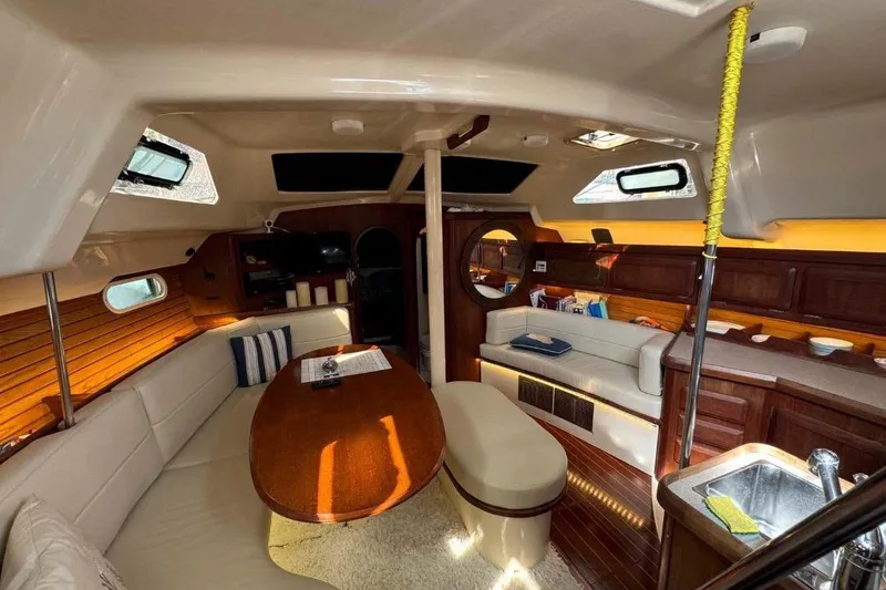 Slide: The Image of Interior of 1997 Hunter Passage 42 yacht with cozy seating and wooden finishes. - 16
