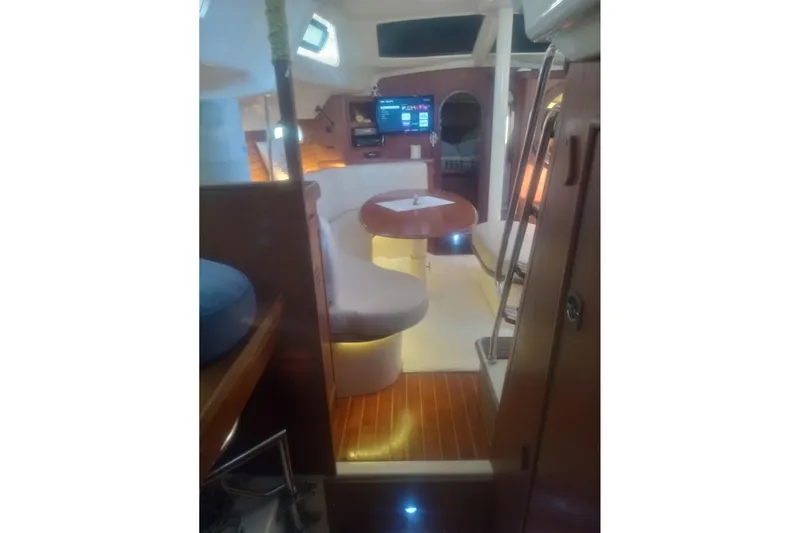 Slide: The Image of Interior of 1997 Hunter Passage 42 yacht with cozy seating and wooden flooring. - 18
