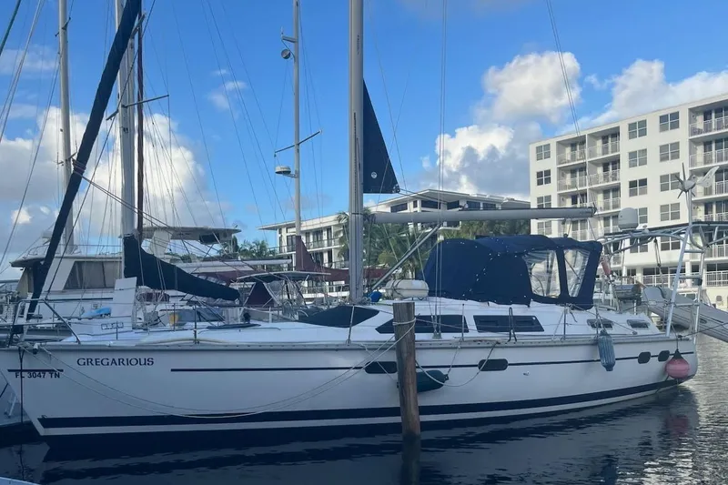 The Image of Hunter Passage 42 sailboat, 1997 model, docked at marina with blue sky background. - 2