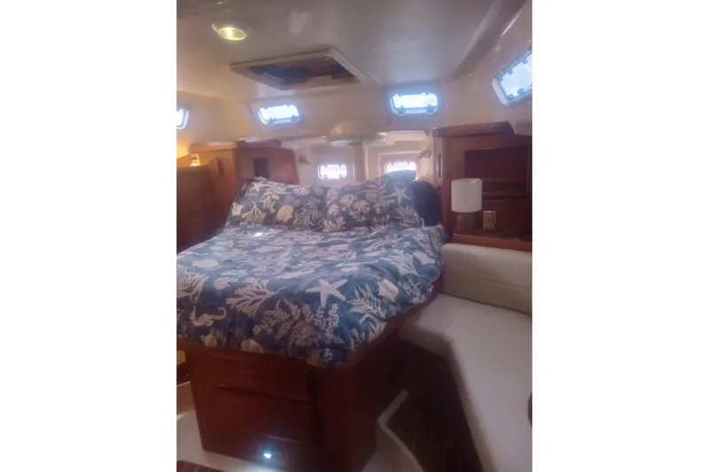 Slide: The Image of Interior cabin of 1997 Hunter Passage 42 sailboat with floral bedding. - 4