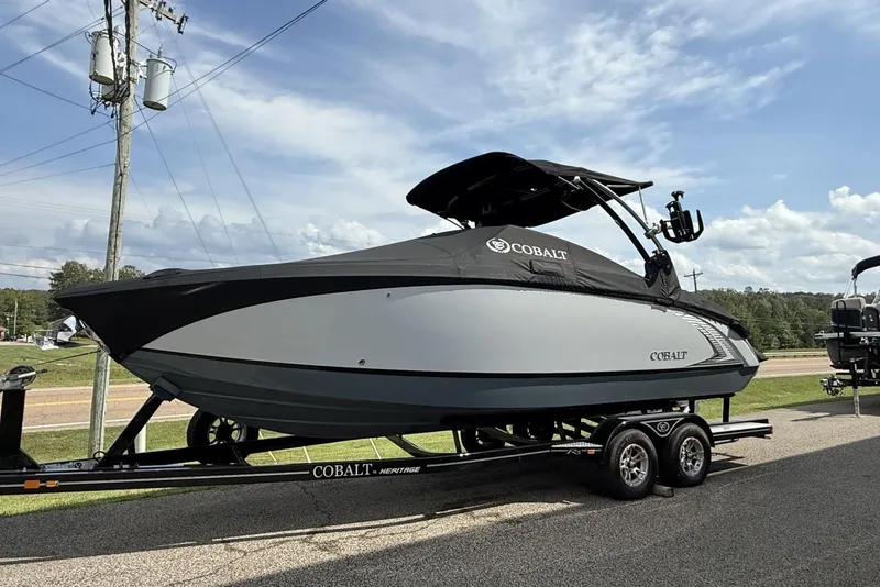 Slide: The Image of 2020 Cobalt R5 Surf boat on trailer, parked outdoors under a clear sky. - 10