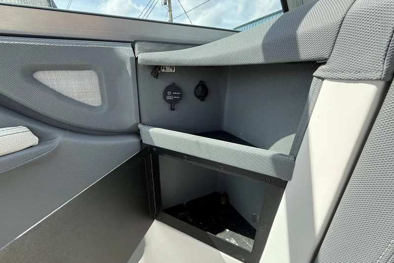 Slide: The Image of Interior view of a 2020 Cobalt R5 Surf boat, featuring storage compartments. - 22