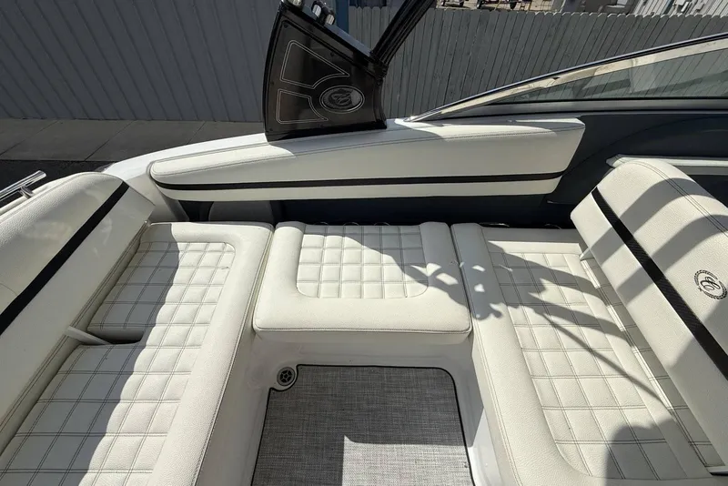 Slide: The Image of 2020 Cobalt R5 Surf boat interior with white cushioned seating and sleek design. - 24