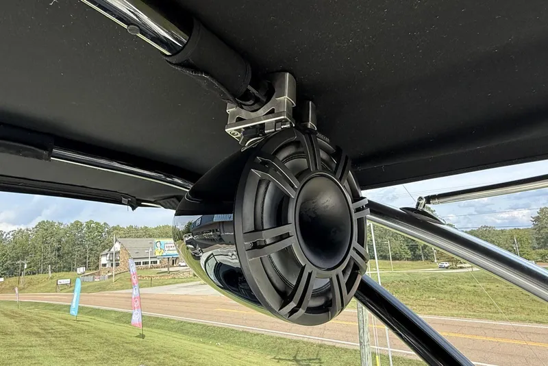 Slide: The Image of 2020 Cobalt R5 Surf boat with mounted speaker, outdoor setting. - 25