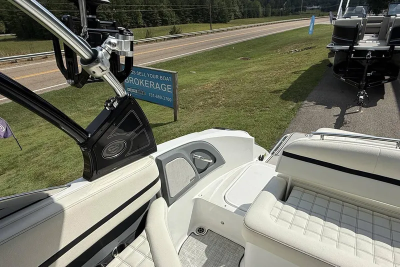 Slide: The Image of 2020 Cobalt R5 Surf boat interior with seating, near brokerage sign and road. - 26