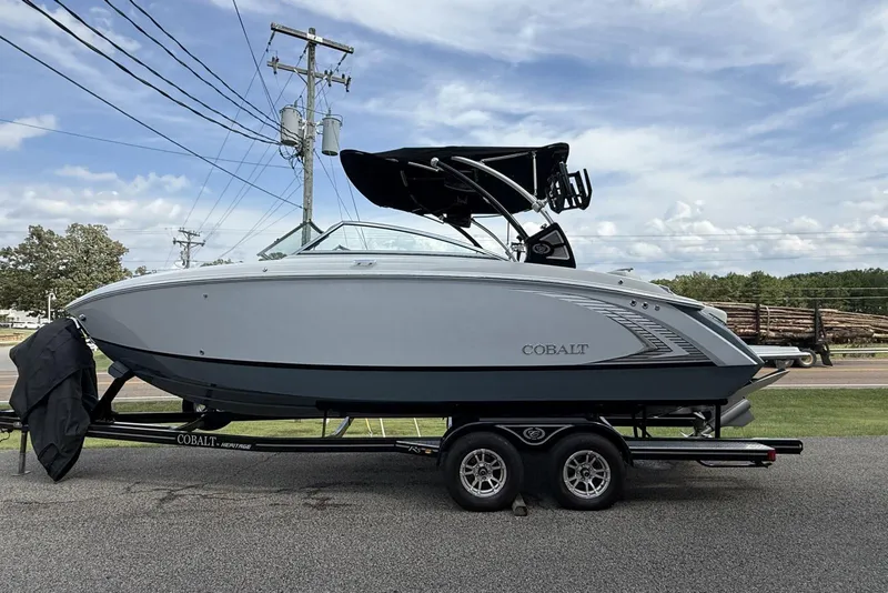 Slide: The Image of 2020 Cobalt R5 Surf boat on trailer, parked outdoors under a cloudy sky. - 28