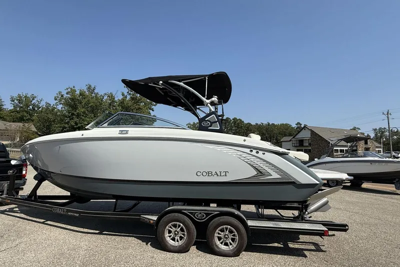 Slide: The Image of 2020 Cobalt R5 Surf boat on trailer, parked outdoors under clear sky. - 36