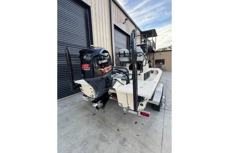 Slide: The Image of 2013 Majek 226 Illusion boat with Yamaha VMAX 332 HP engine, parked outside a building. - 10