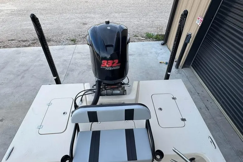 Slide: The Image of 2013 Majek 226 Illusion boat with powerful 332 Nizpro engine, docked near a garage. - 12