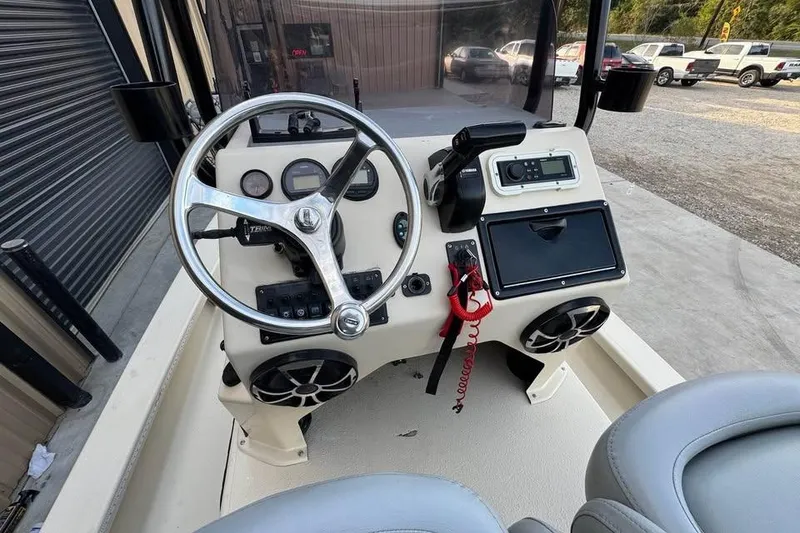 Slide: The Image of 2013 Majek 226 Illusion boat console with steering wheel and controls. - 3