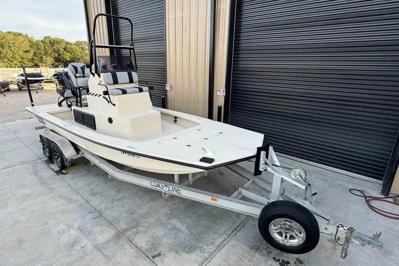 Slide: The Image of 2013 Majek 226 Illusion boat on trailer, parked outside a garage. - 8