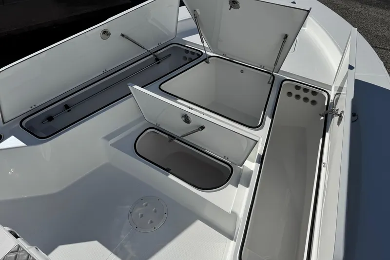 Slide: The Image of Open storage compartments on a 2026 BlackJack 256 Bay boat deck. - 10