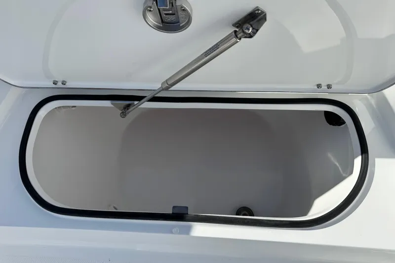 Slide: The Image of Open storage compartment on 2026 BlackJack 256 Bay boat. - 11