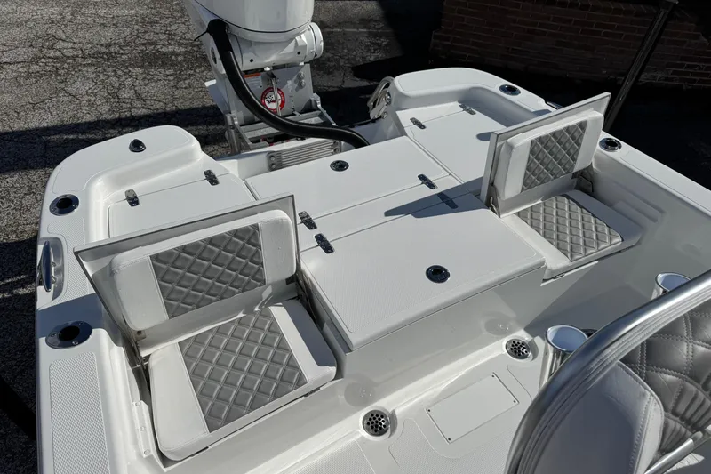 Slide: The Image of 2026 BlackJack 256 Bay boat interior with foldable seats and storage compartments. - 17