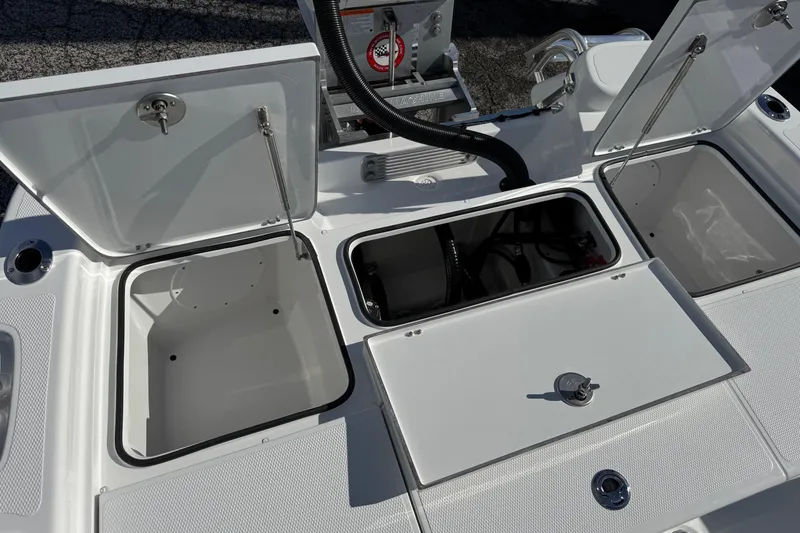 Slide: The Image of Open storage compartments on a 2026 BlackJack 256 Bay boat deck. - 19