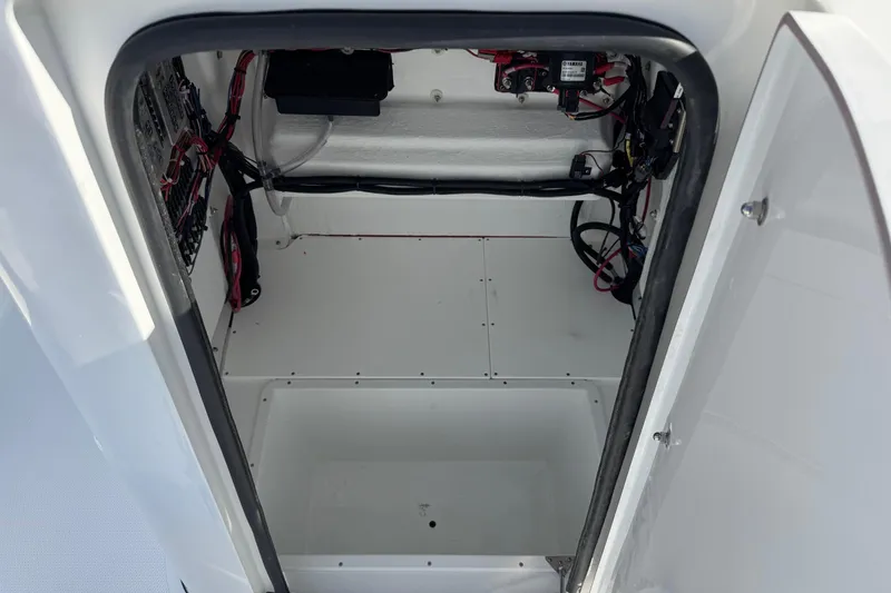 Slide: The Image of Interior view of 2026 BlackJack 256 Bay boat compartment with wiring and storage space. - 21