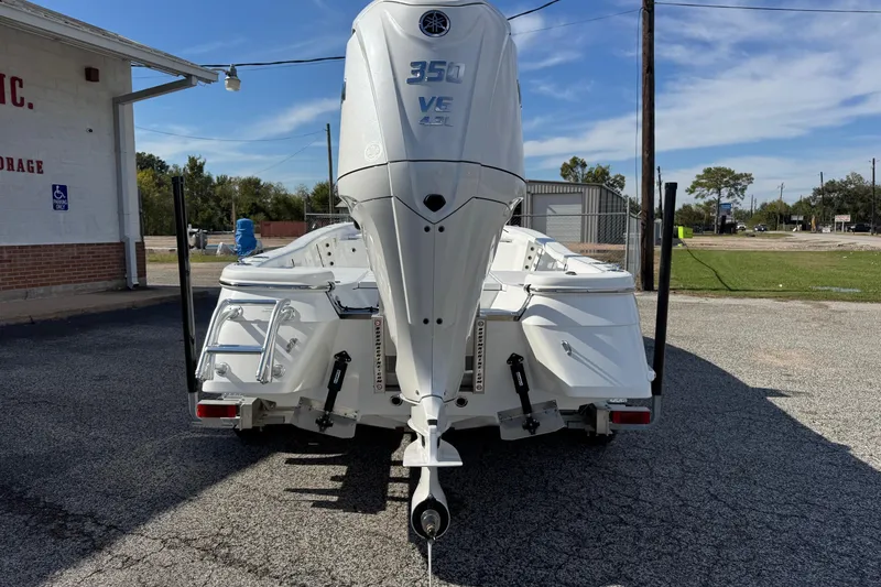 Slide: The Image of 2026 BlackJack 256 Bay boat with Yamaha 350 engine, parked outdoors. - 4