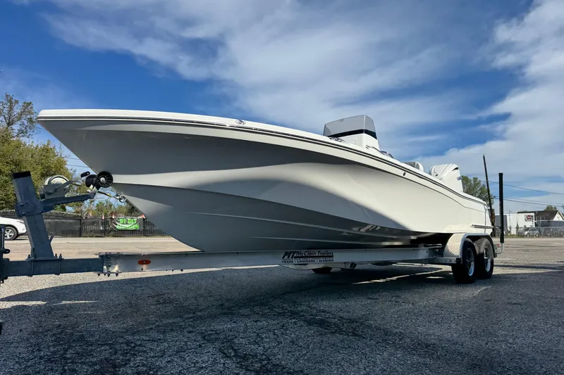Slide: The Image of 2026 BlackJack 256 Bay boat on trailer under clear blue sky. - 6
