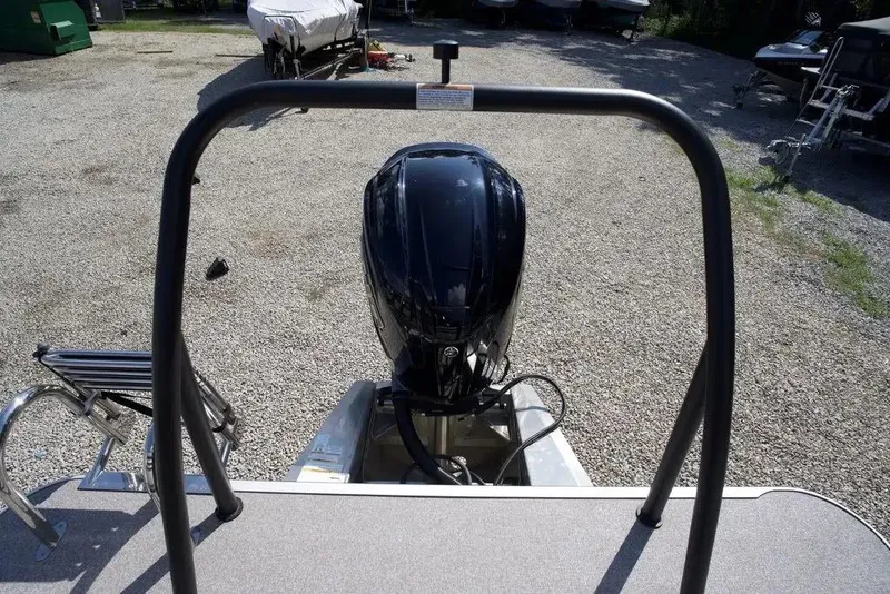 Slide: The Image of 2023 Veranda VP 22RC boat with outboard motor in a gravel lot. - 15
