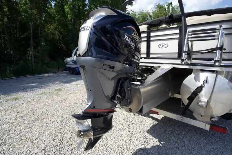Slide: The Image of 2023 Veranda VP 22RC pontoon boat with Yamaha outboard motor, parked on gravel. - 16