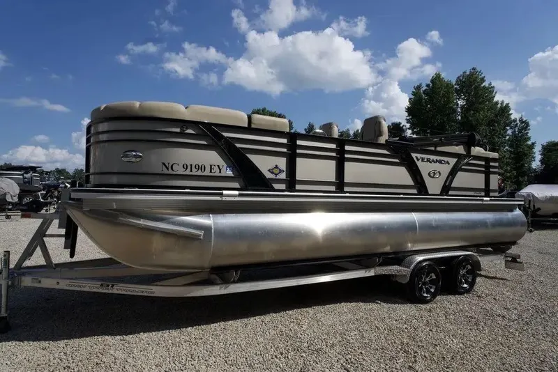 Slide: The Image of 2023 Veranda VP 22RC pontoon boat on trailer under blue sky. - 4