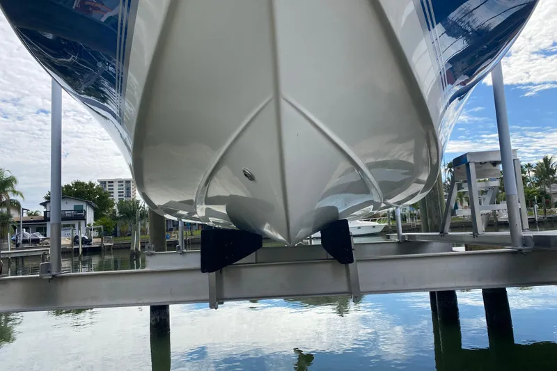 Slide: The Image of 2004 Palmetto 22 Excursion boat on lift, reflecting on calm water. - 11