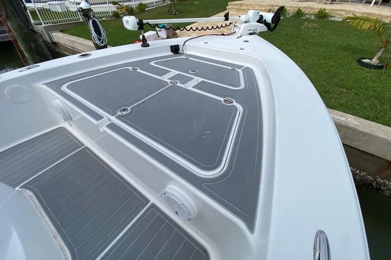 Slide: The Image of 2004 Palmetto 22 Excursion boat deck with storage compartments and trolling motor. - 17