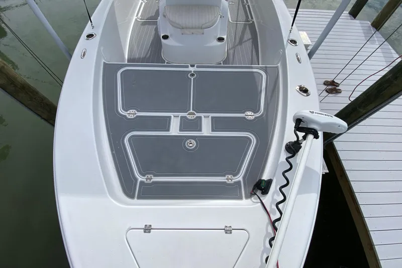 Slide: The Image of 2004 Palmetto 22 Excursion boat deck with trolling motor, docked by wooden pier. - 21