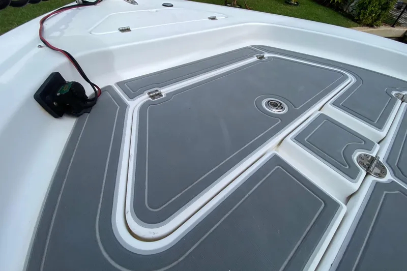 Slide: The Image of 2004 Palmetto 22 Excursion boat deck with gray non-slip surface and storage compartments. - 22