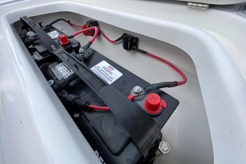 Slide: The Image of Battery compartment of 2004 Palmetto 22 Excursion boat with red and black cables. - 24