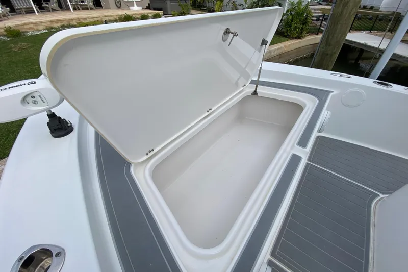 Slide: The Image of Open storage compartment on 2004 Palmetto 22 Excursion boat, showcasing spacious interior. - 26