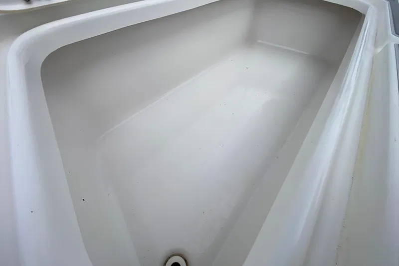 Slide: The Image of Storage compartment of 2004 Palmetto 22 Excursion boat, featuring clean white interior. - 27