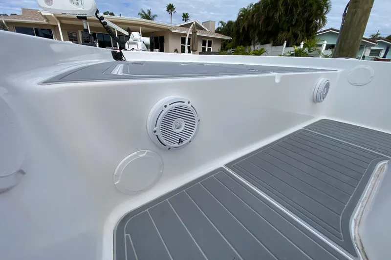 Slide: The Image of 2004 Palmetto 22 Excursion boat interior with speakers and gray flooring. - 28