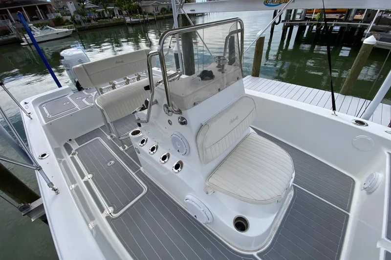 Slide: The Image of 2004 Palmetto 22 Excursion boat interior with seating and console, docked by the water. - 31