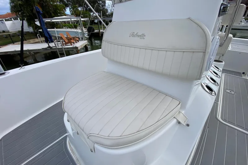 Slide: The Image of White cushioned seating on 2004 Palmetto 22 Excursion boat, dockside view. - 32