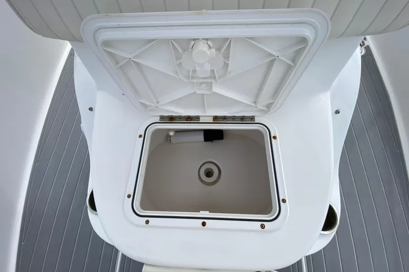 Slide: The Image of Open storage compartment on 2004 Palmetto 22 Excursion boat, featuring white interior and gray flooring. - 34