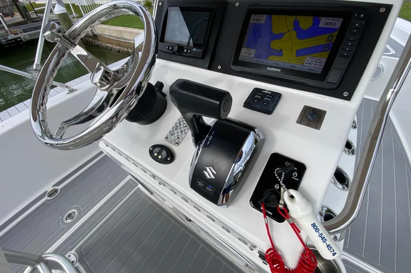 Slide: The Image of Control panel of 2004 Palmetto 22 Excursion boat with steering wheel and navigation system. - 43