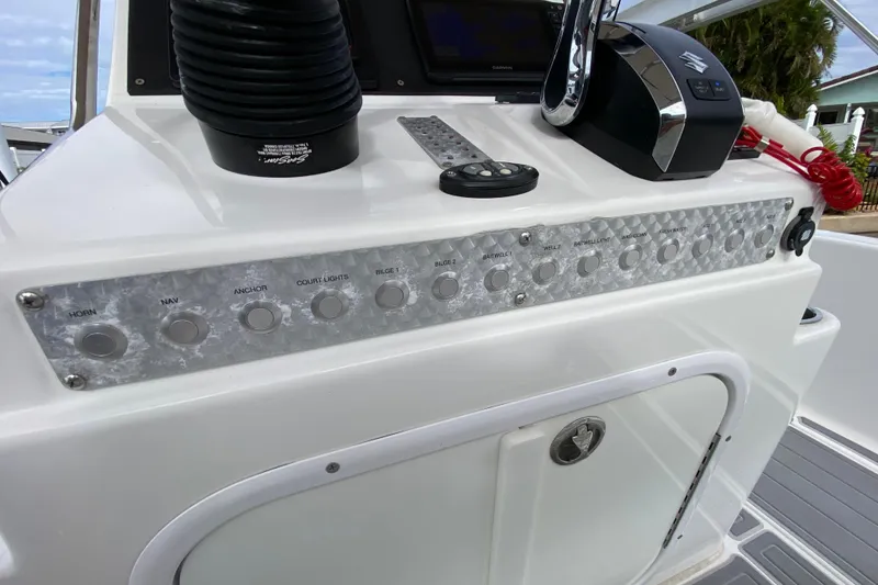 Slide: The Image of Control panel of a 2004 Palmetto 22 Excursion boat with various switches and controls. - 44