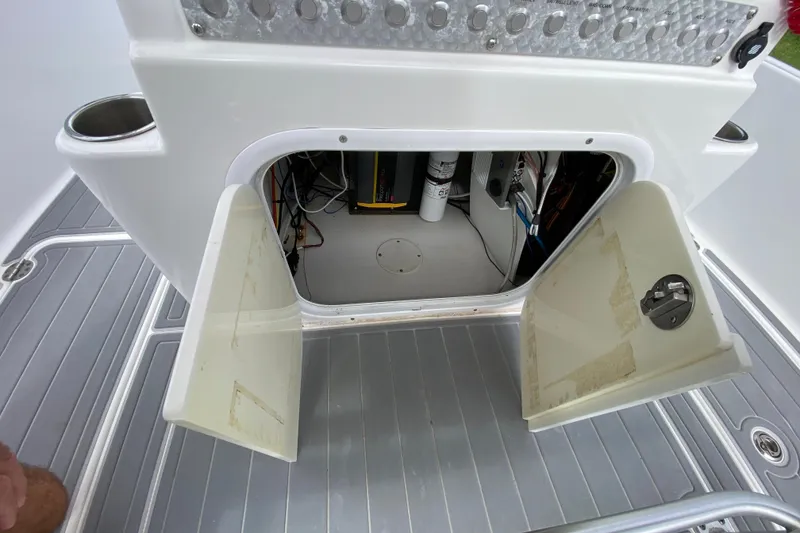 Slide: The Image of Open storage compartment on 2004 Palmetto 22 Excursion boat, revealing interior wiring and equipment. - 45