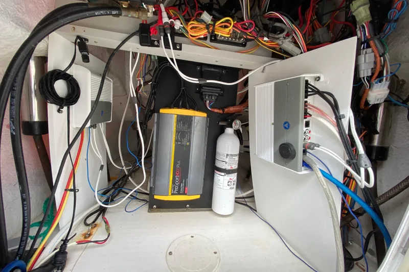 Slide: The Image of Electrical system inside a 2004 Palmetto 22 Excursion boat, featuring wiring and equipment. - 46
